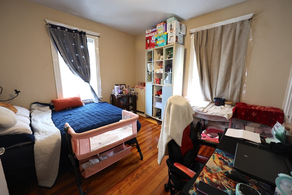 33-35 Ridgemont Street, Unit 1 Boston, MA 02134 - Photo 7 of 10 a living room with furniture a rug and a window