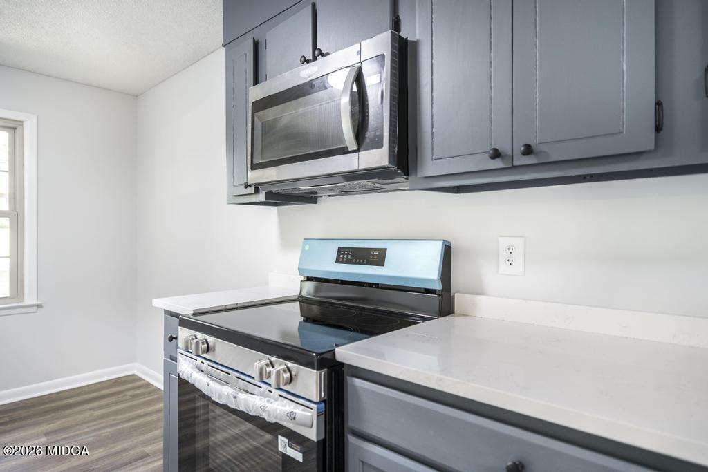 303 Woodhaven Road Centerville, GA 31028 - Photo 14 of 35 a kitchen with a stove and a microwave