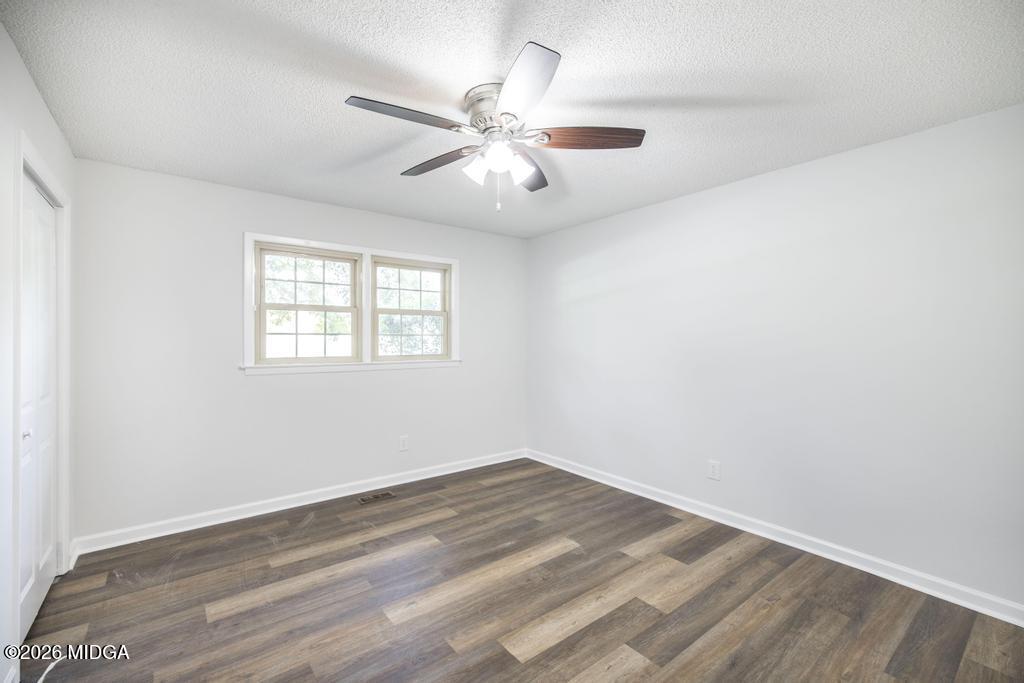303 Woodhaven Road Centerville, GA 31028 - Photo 18 of 35 wooden floor in an empty room with a window