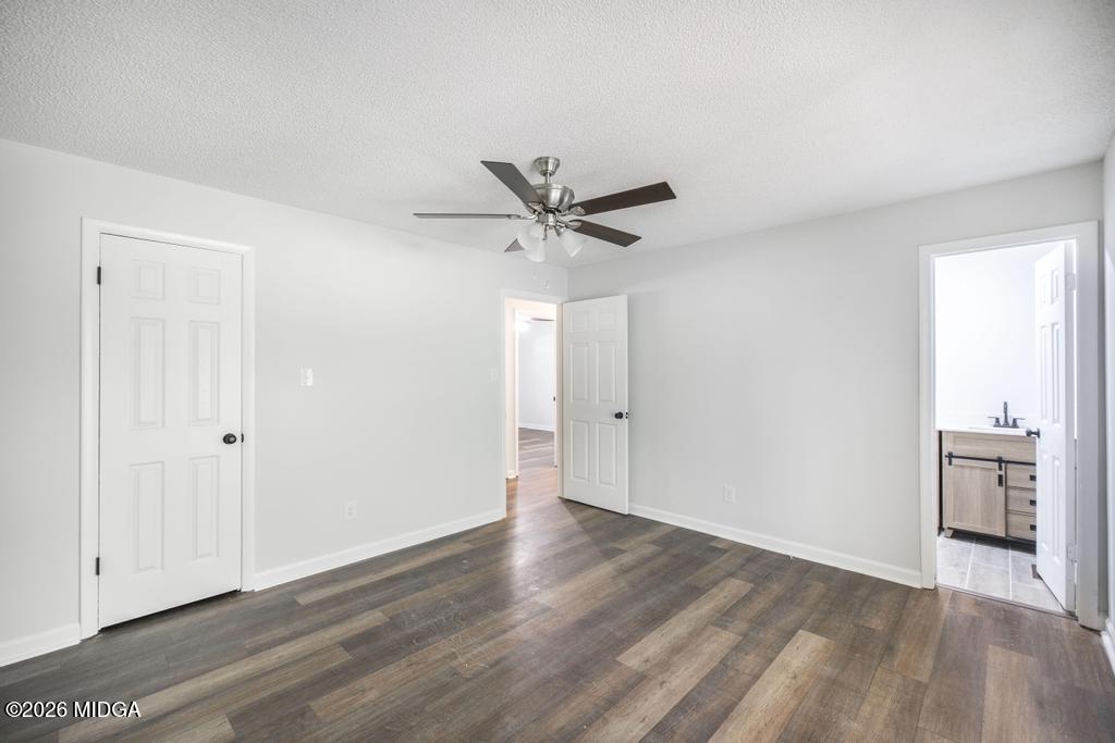 303 Woodhaven Road Centerville, GA 31028 - Photo 25 of 35 an empty room with wooden floor and a ceiling fan