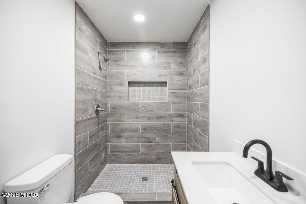 303 Woodhaven Road Centerville, GA 31028 - Photo 27 of 35 a bathroom with a sink toilet and shower