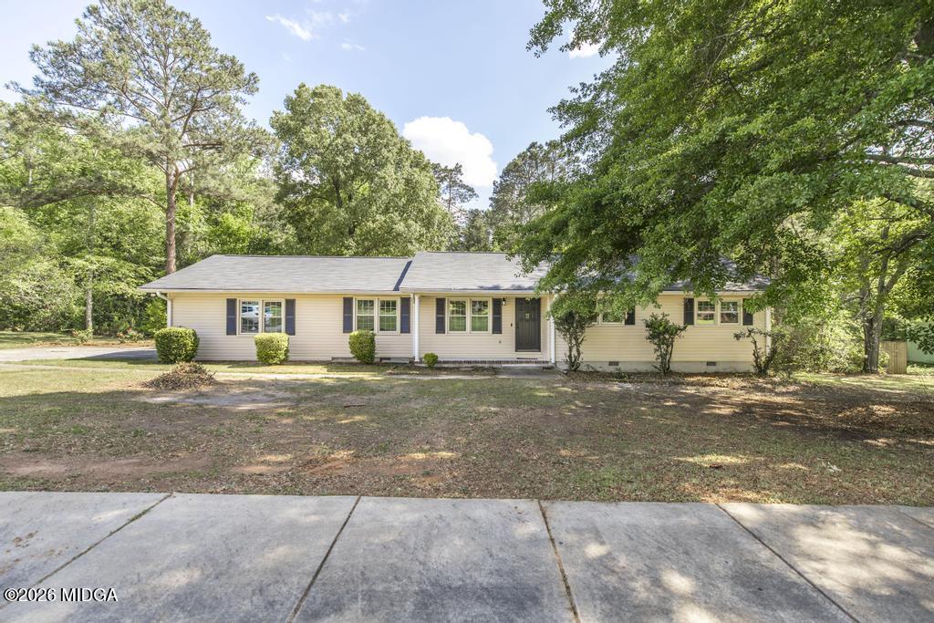 303 Woodhaven Road Centerville, GA 31028 - Photo 3 of 35 a front view of a house with a garden and trees