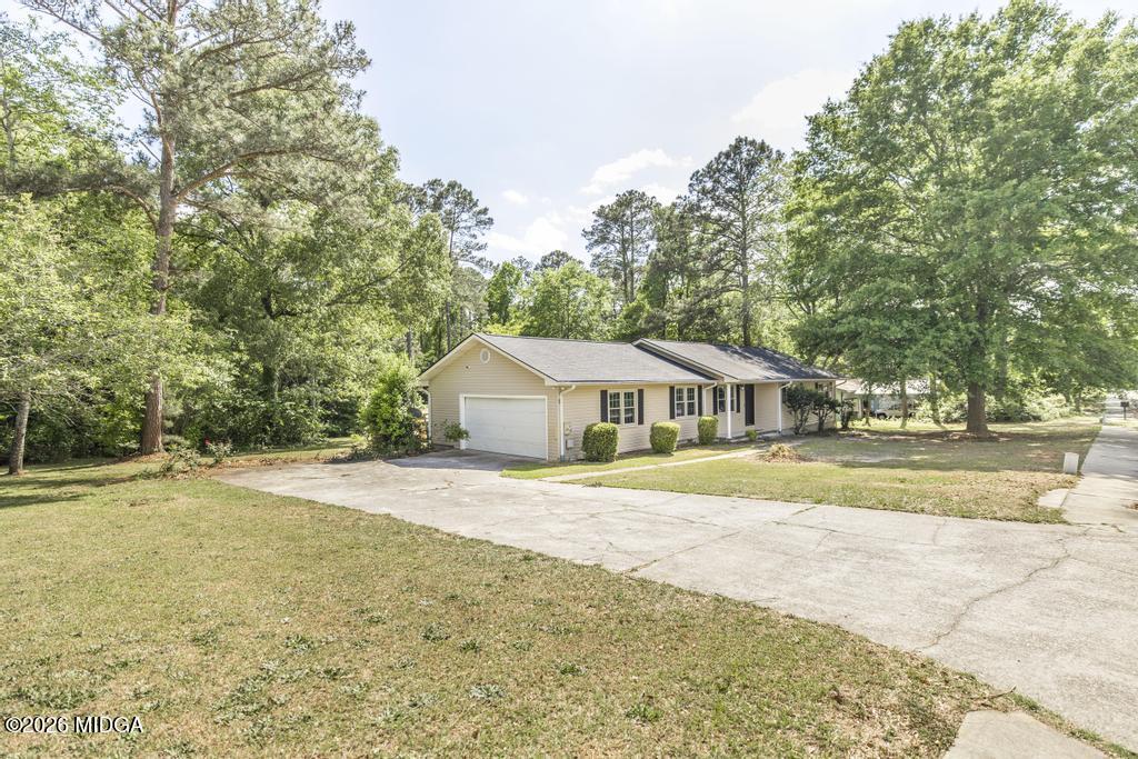 303 Woodhaven Road Centerville, GA 31028 - Photo 4 of 35 a view of an house with backyard and trees
