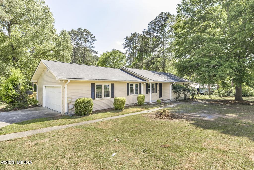 303 Woodhaven Road Centerville, GA 31028 - Photo 5 of 35 a view of a house with a big yard and large trees