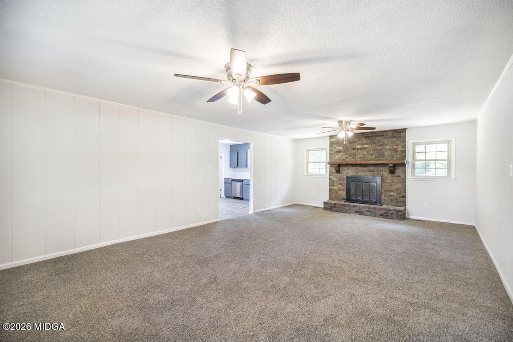 303 Woodhaven Road Centerville, GA 31028 - Photo 7 of 35 a view of empty room with fireplace and ceiling fan