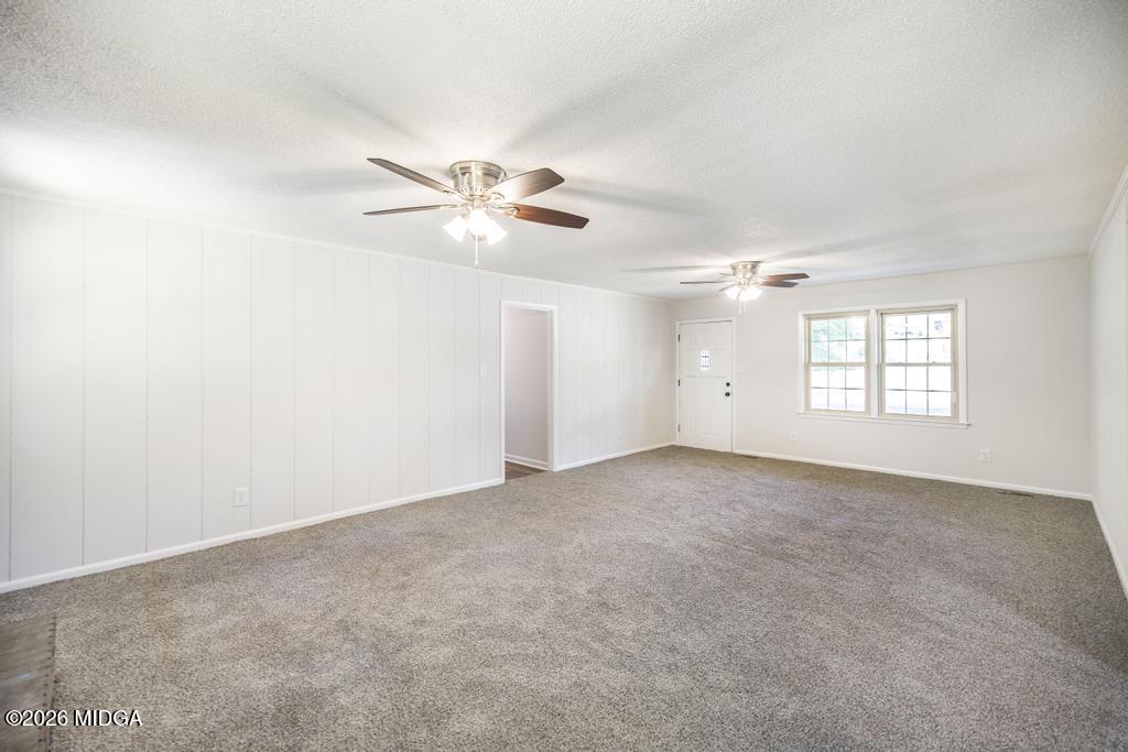 303 Woodhaven Road Centerville, GA 31028 - Photo 9 of 35 an empty room with a window and a ceiling fan