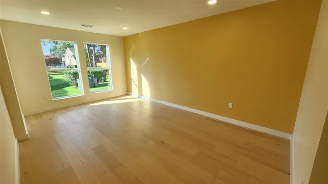 a bedroom with a bed and painting on the wall