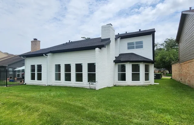 a big house with a big yard and more large trees