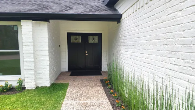 a front view of a house with a garden