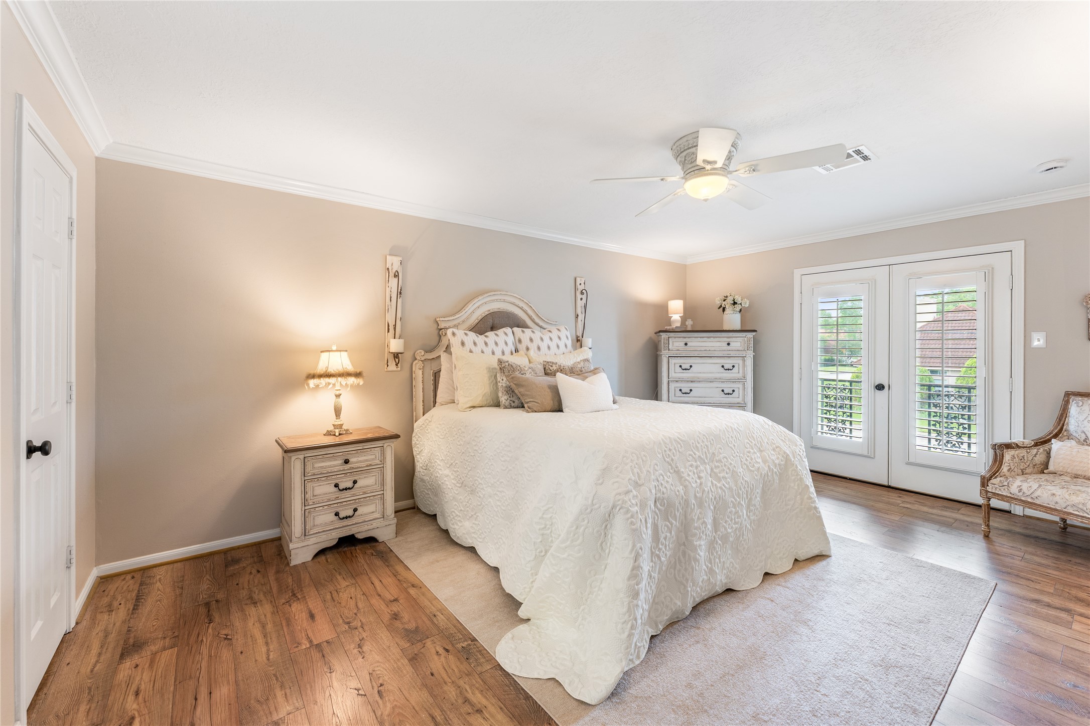 3301 Winter Lane Baytown, TX 77521 - Photo 14 of 28 Cozy and elegant bedroom, neutral walls, and a ceiling fan. French doors leading to balcony, allows natural light to fill the space. Great for having your coffee out there before you start your day.