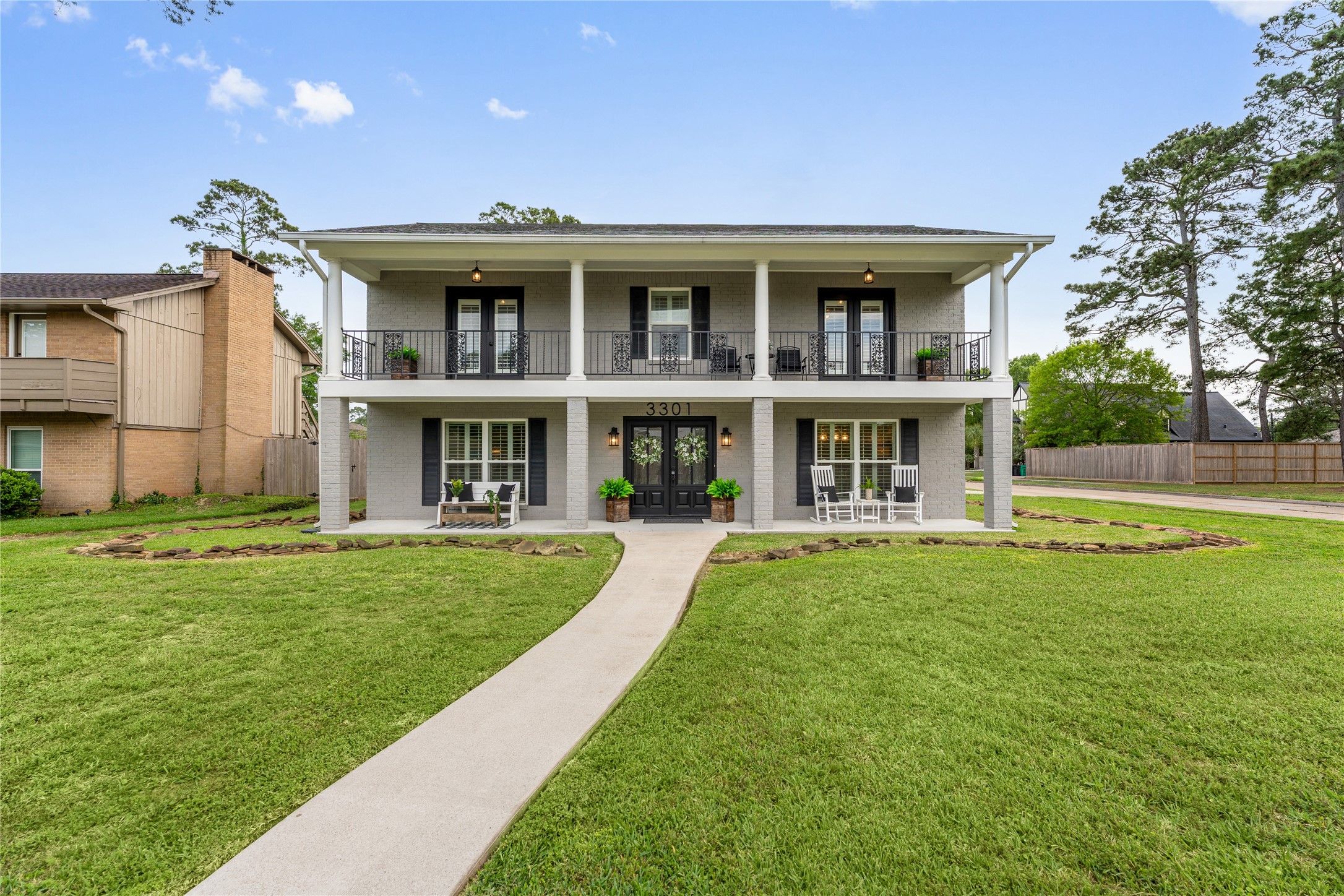 3301 Winter Lane Baytown, TX 77521 - Photo 2 of 28 Corner lot showcasing a charming two-story home with a welcoming front porch, balcony, and graceful tall columns that add timeless Southern elegance to its curb appeal. The well-maintained lawn enhances the home’s warm, inviting presence, and it is ideally situated near walking trails and neighborhood parks.