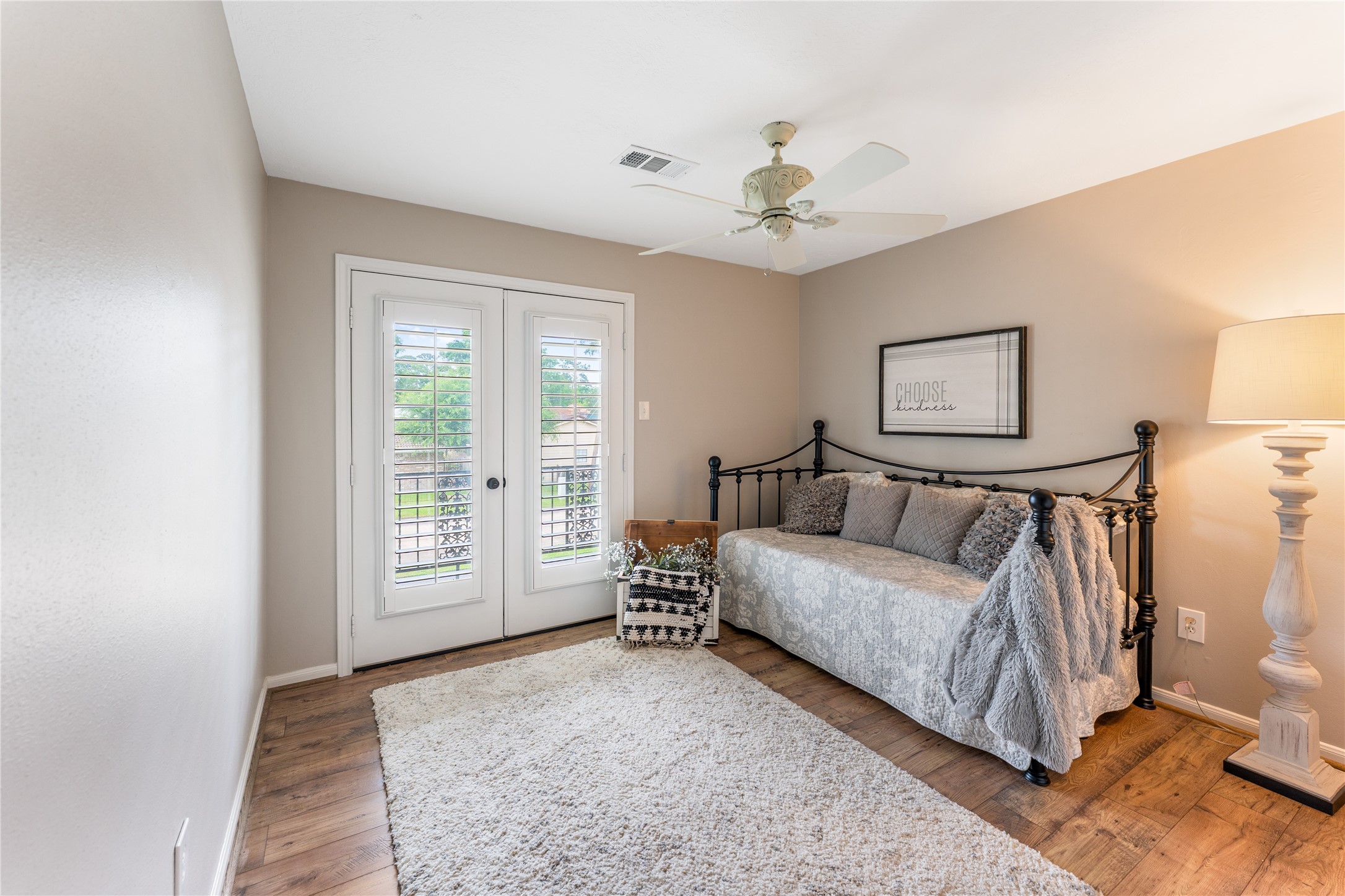 3301 Winter Lane Baytown, TX 77521 - Photo 22 of 28 This cozy bedroom features French doors with shutters with access to the balcony.