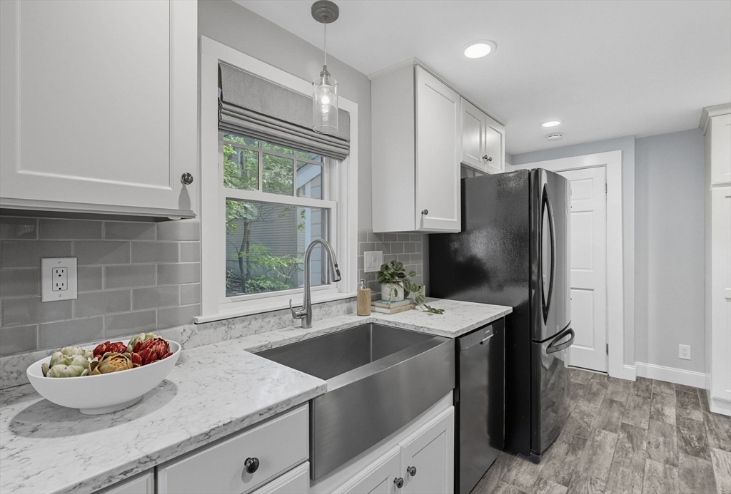 571 Washington Street Winchester, MA 01890 - Photo 14 of 35 a kitchen with granite countertop a sink stainless steel appliances and cabinets