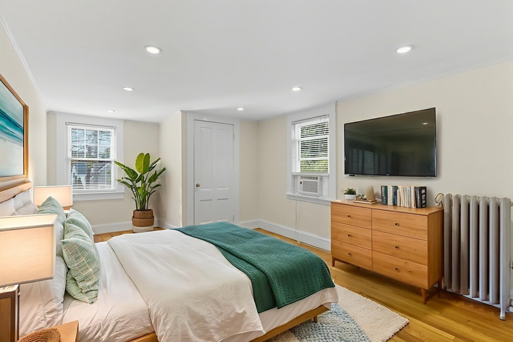 571 Washington Street Winchester, MA 01890 - Photo 24 of 35 a bedroom with a bed and a flat screen tv