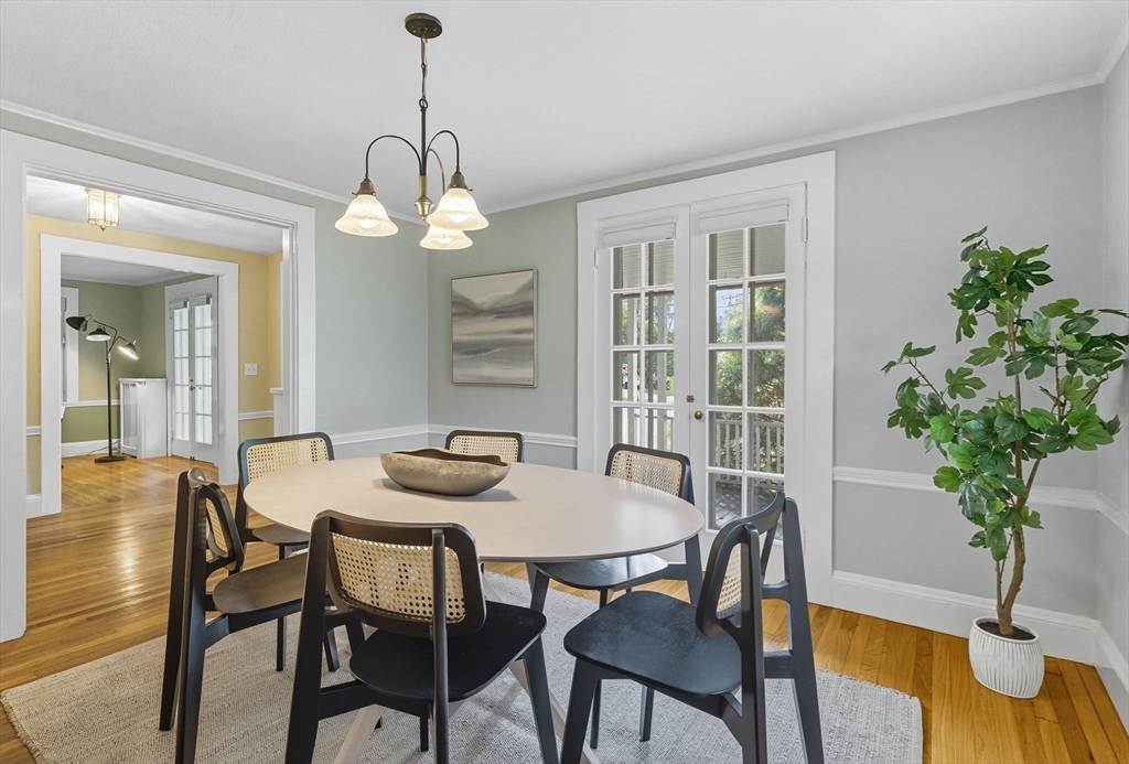 571 Washington Street Winchester, MA 01890 - Photo 9 of 35 a dining room with furniture potted plants and wooden floor