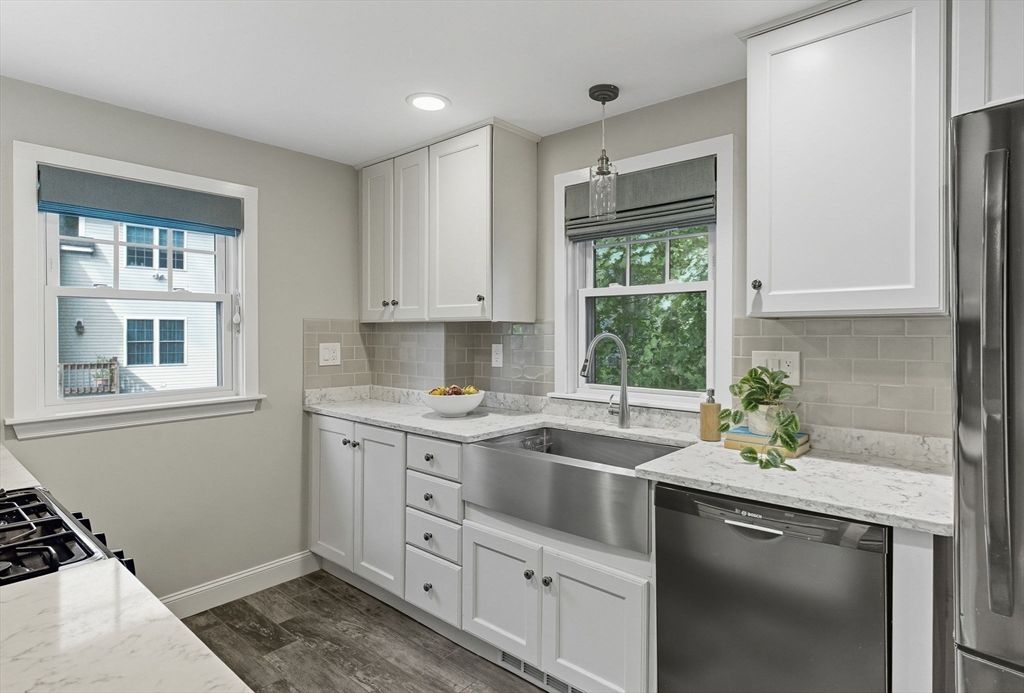 571 Washington Street Winchester, MA 01890 - Photo 10 of 35 a kitchen with a sink stove and cabinets