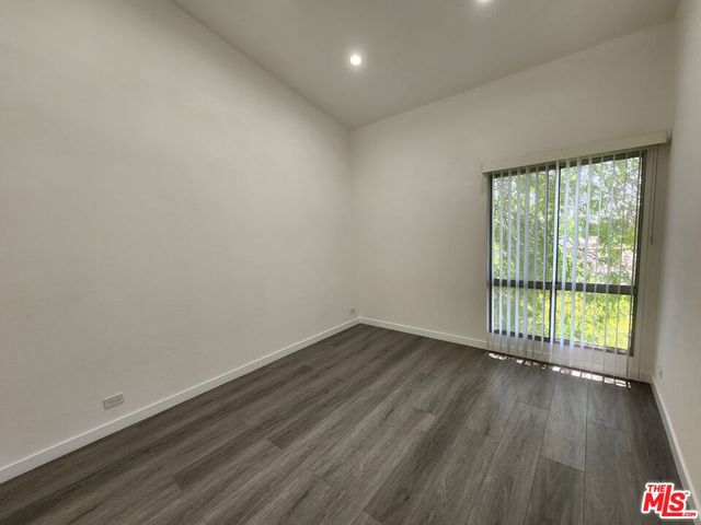 a view of wooden floor and windows in a room