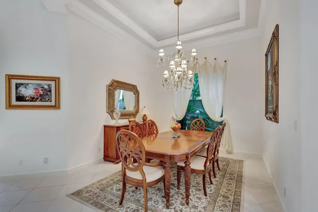 a living room with kitchen island furniture and a chandelier