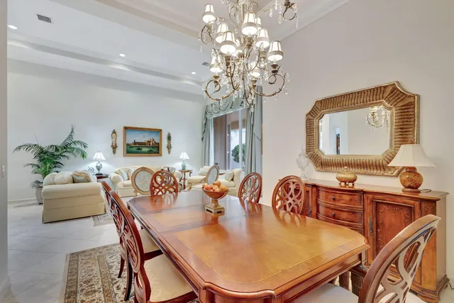 a living room with kitchen island furniture and a chandelier