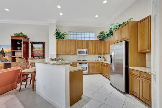 a living room with furniture a fireplace and a chandelier