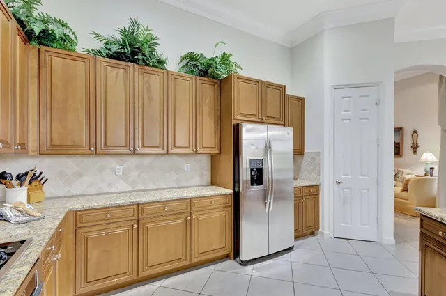 a bedroom with a bed and a flat tv screen on dresser