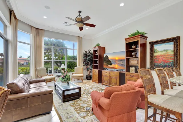 a view of a porch with chairs and floor to ceiling window