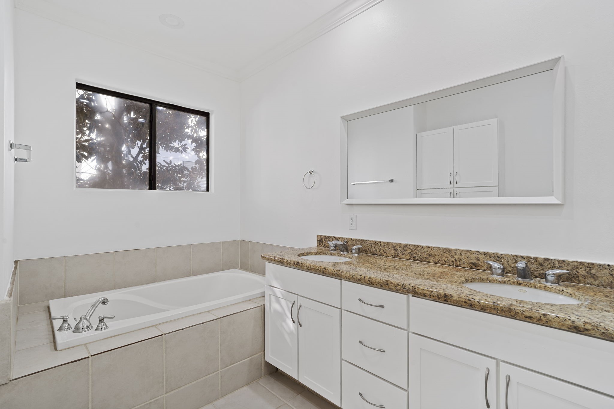 2547 Rusk Street Houston, TX 77003 - Photo 12 of 22 a bathroom with a granite countertop tub sink and mirror