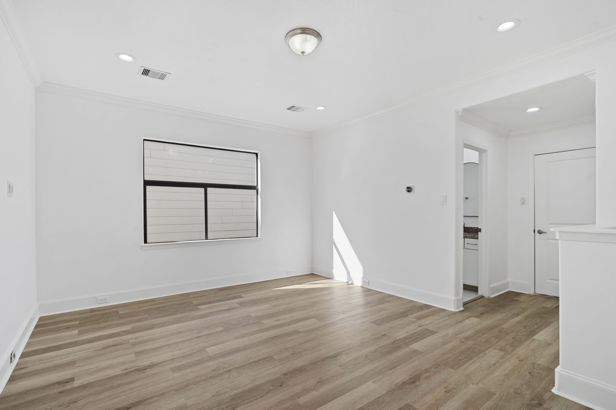 2547 Rusk Street Houston, TX 77003 - Photo 13 of 22 a view of empty room with wooden floor and window