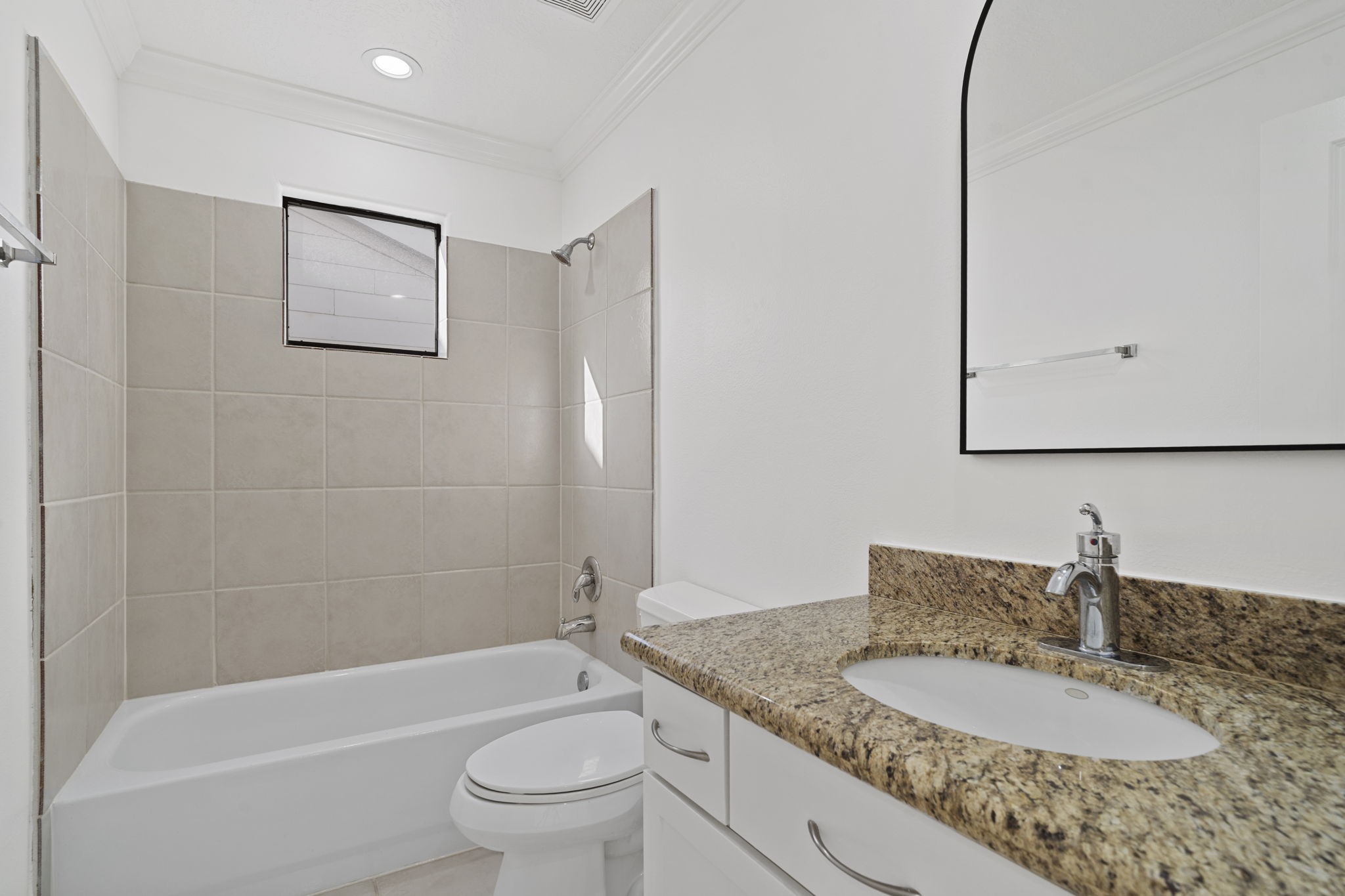 2547 Rusk Street Houston, TX 77003 - Photo 15 of 22 a bathroom with a granite countertop sink a toilet and bathtub