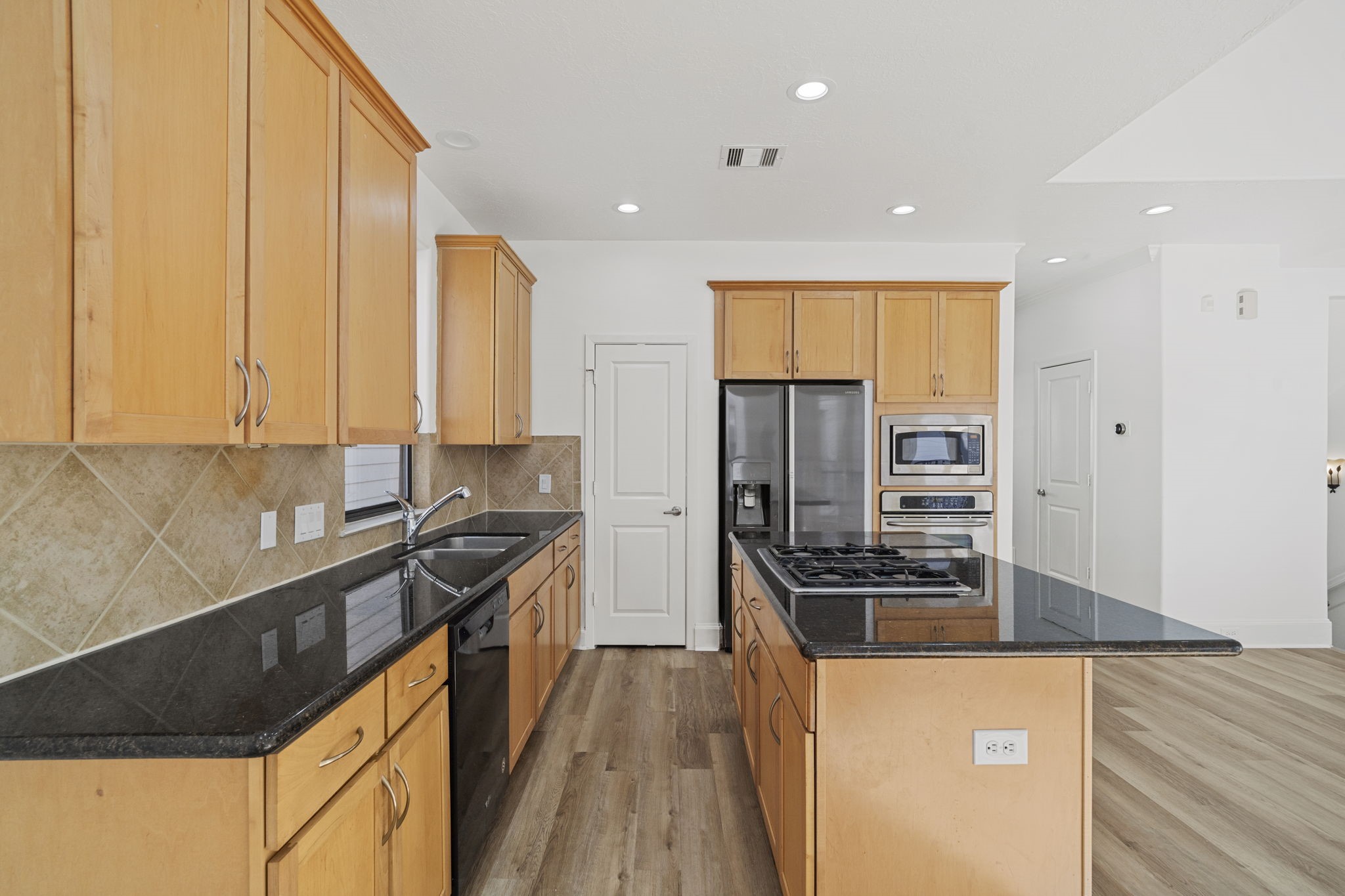 2547 Rusk Street Houston, TX 77003 - Photo 7 of 22 a kitchen with stainless steel appliances a sink stove and refrigerator