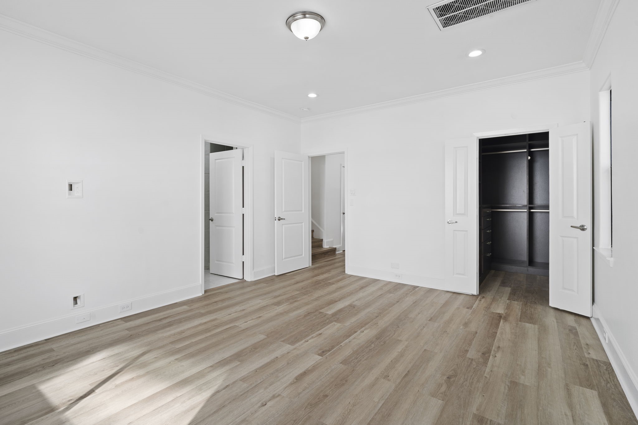 2547 Rusk Street Houston, TX 77003 - Photo 10 of 22 a view of an empty room with wooden floor and closet