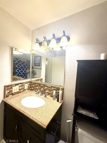 a bathroom with a sink vanity and a mirror