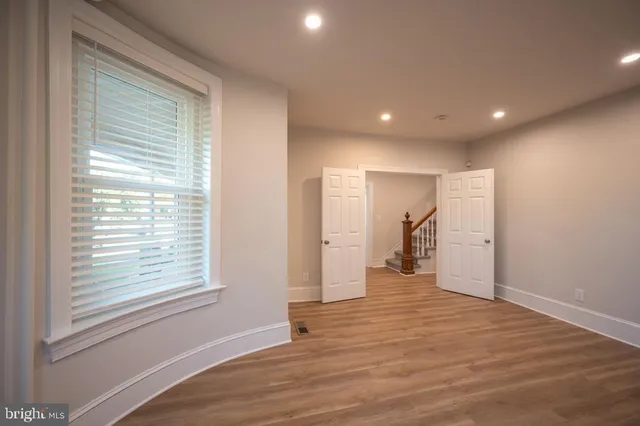 a view of a room with wooden floor and a window