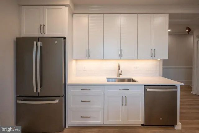 a kitchen with granite countertop cabinets and refrigerator