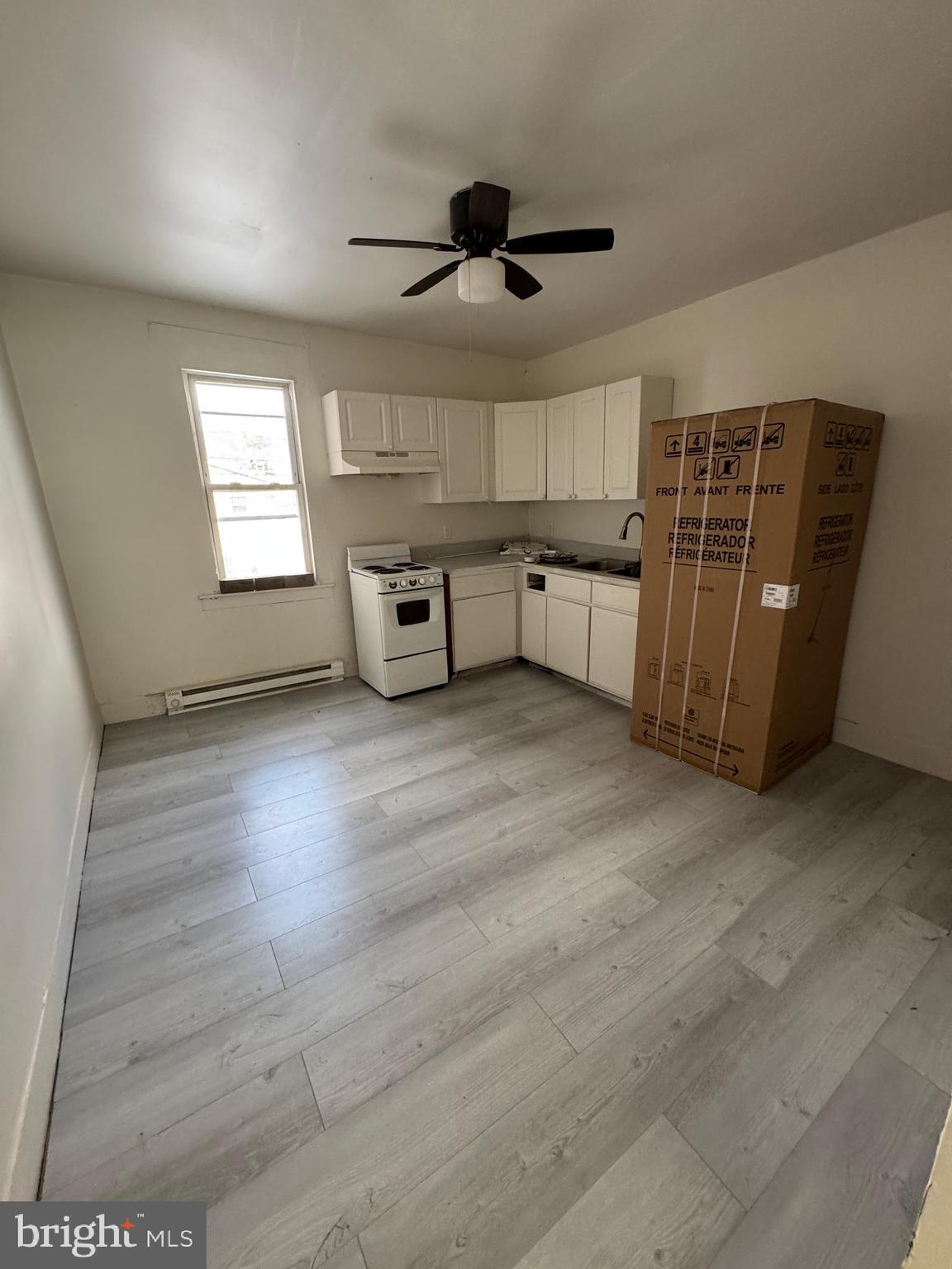 1931 Walnut Street Ashland, PA 17921 - Photo 3 of 6 an empty room with wooden floor and windows