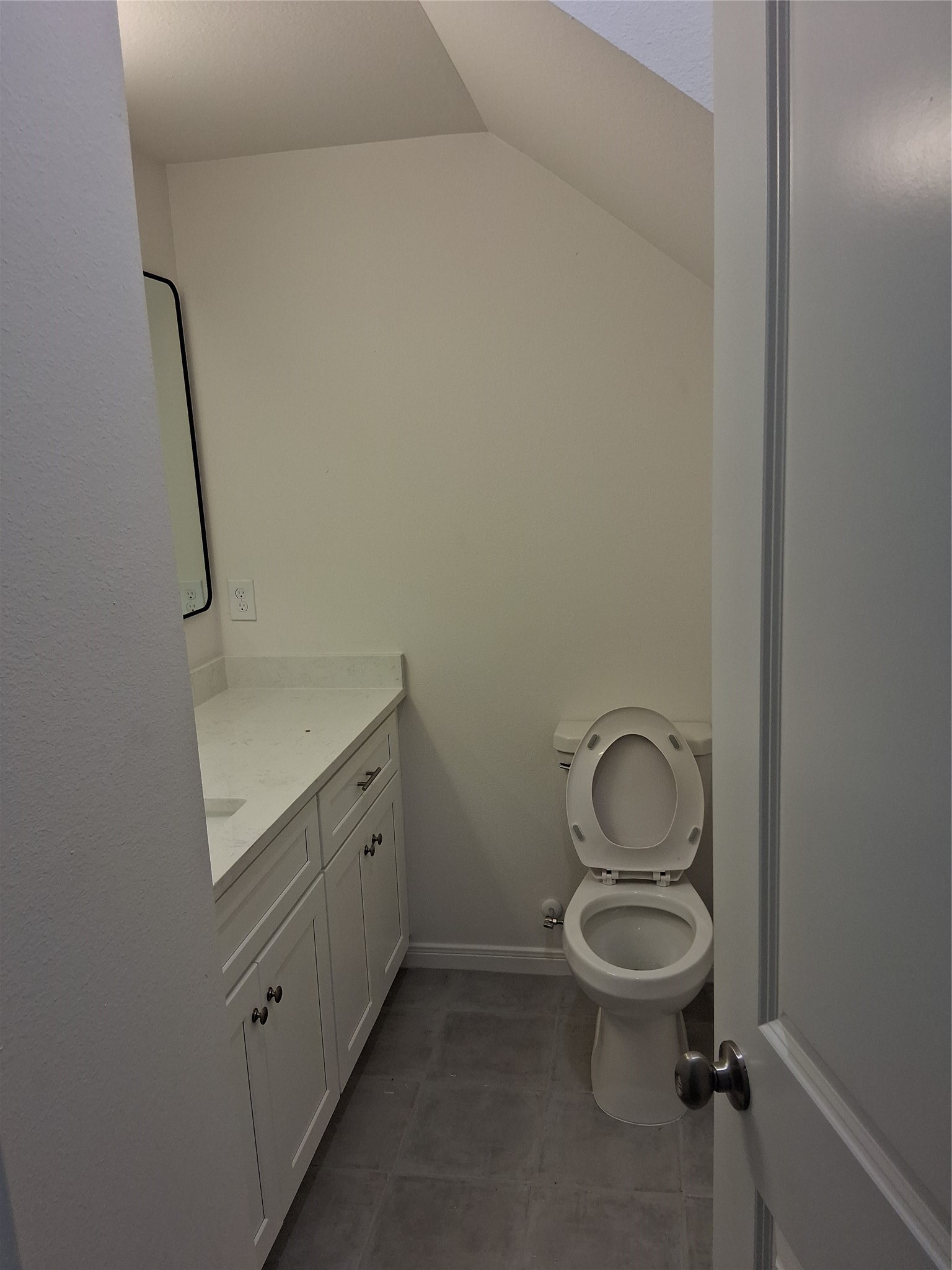6835 Landor Street Houston, TX 77028 - Photo 11 of 32 a bathroom with a granite countertop toilet a sink and a mirror