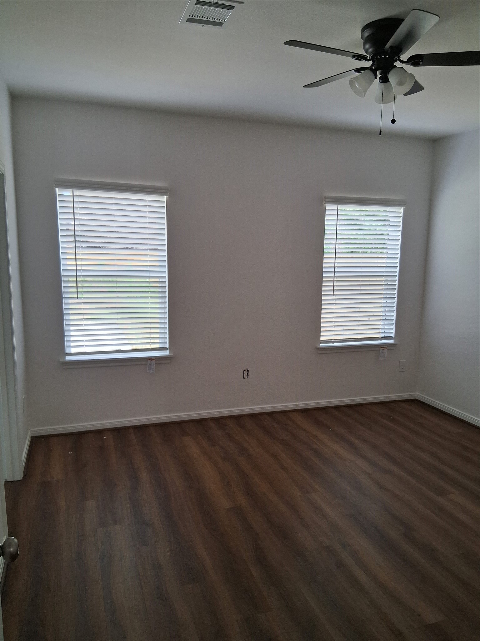 6835 Landor Street Houston, TX 77028 - Photo 16 of 32 an empty room with wooden floor fan and windows