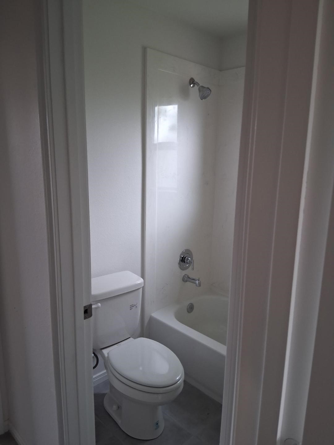 6835 Landor Street Houston, TX 77028 - Photo 27 of 32 a bathroom with a granite countertop toilet and a bathtub