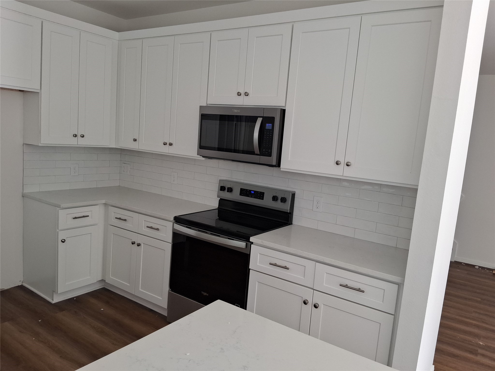 6835 Landor Street Houston, TX 77028 - Photo 8 of 32 a kitchen with white cabinets and black appliances