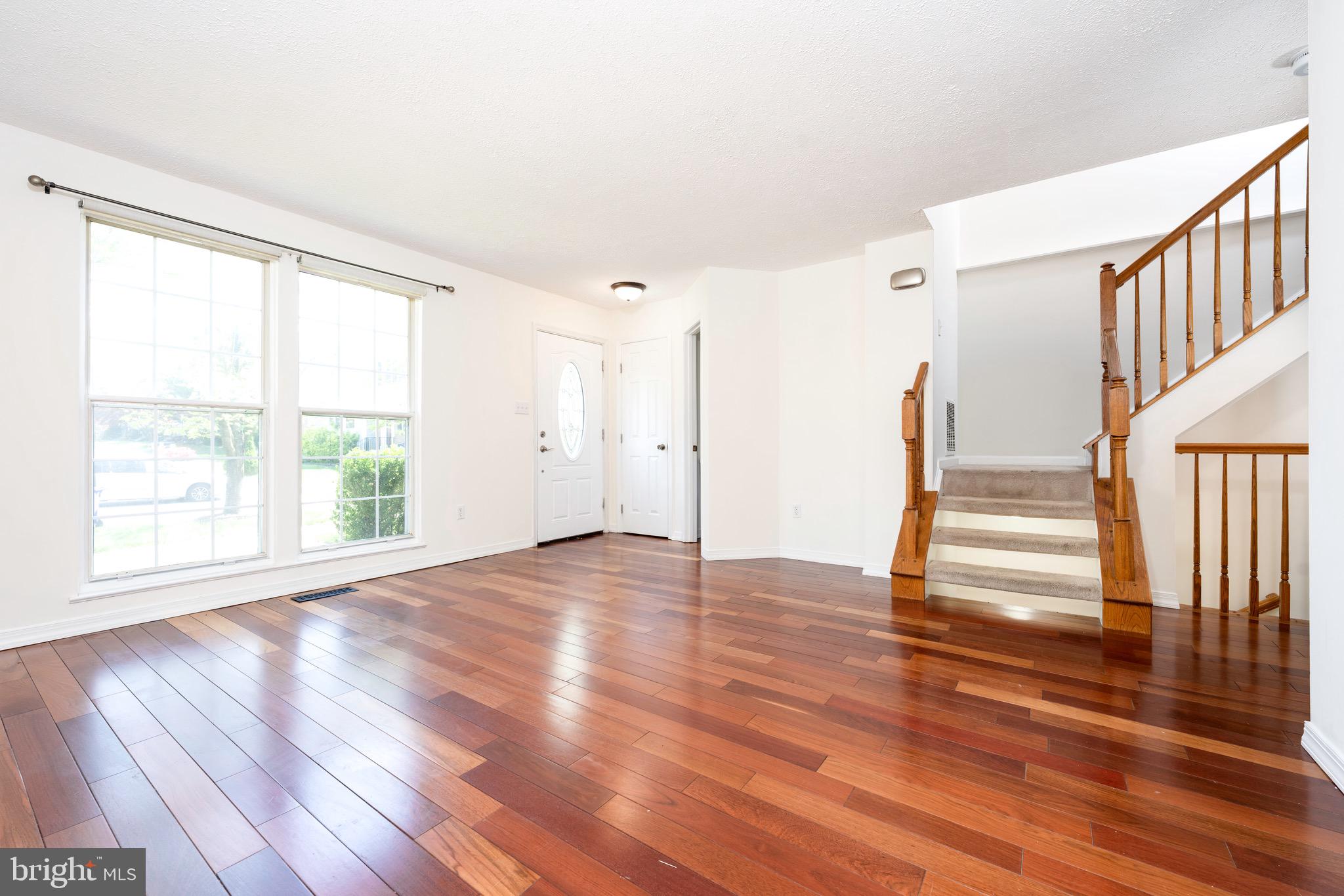 5490 Prince William Court Frederick, MD 21703 - Photo 18 of 25 Bright and open living room with hardwood floor