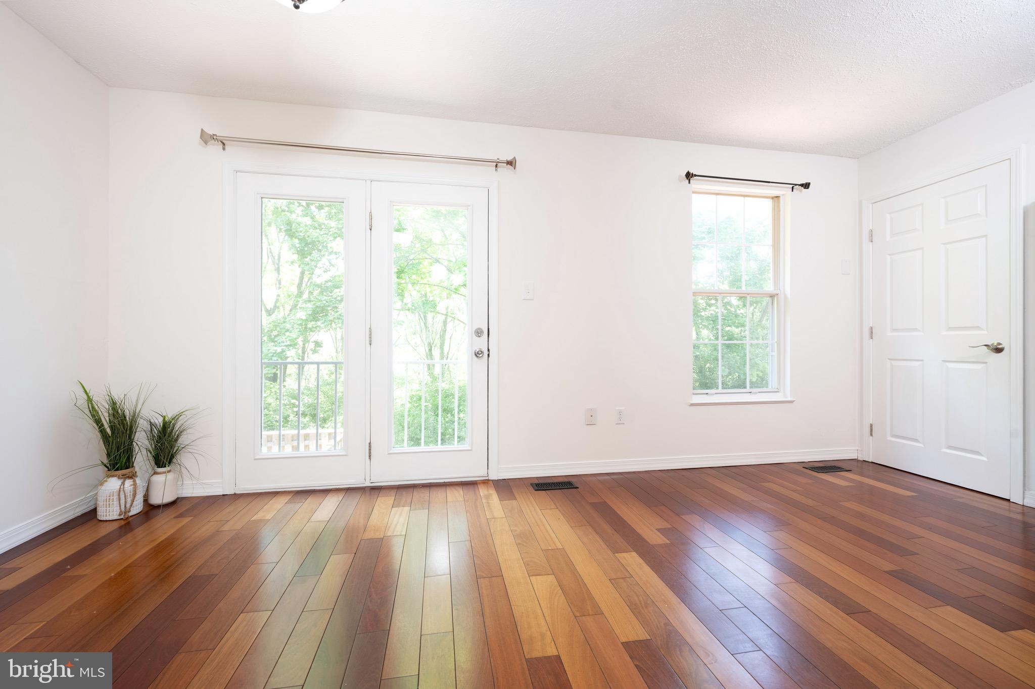 5490 Prince William Court Frederick, MD 21703 - Photo 19 of 25 Dining area with large glass door and hardwood