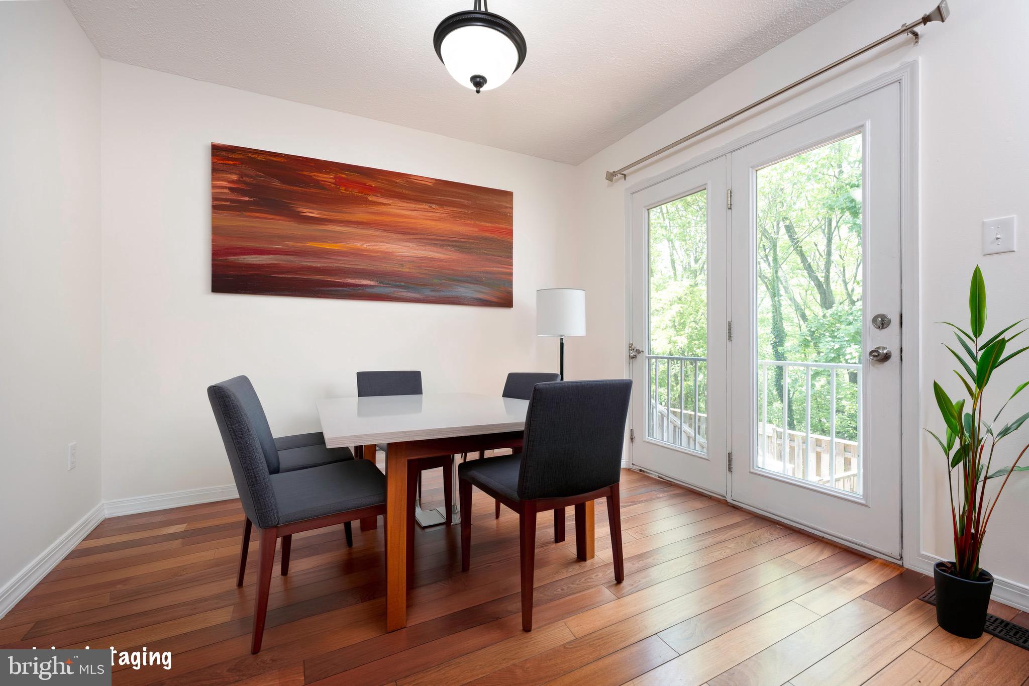 5490 Prince William Court Frederick, MD 21703 - Photo 4 of 25 Dining area with large glass door and hardwood