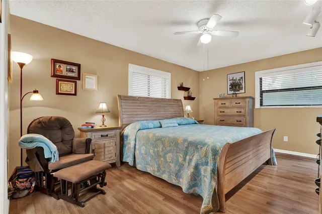 a bedroom with a bed and wooden floor