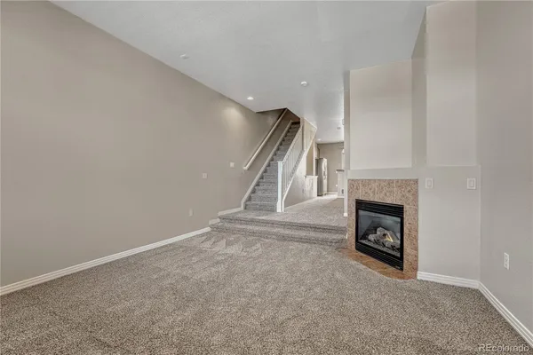 a view of empty room with a fireplace