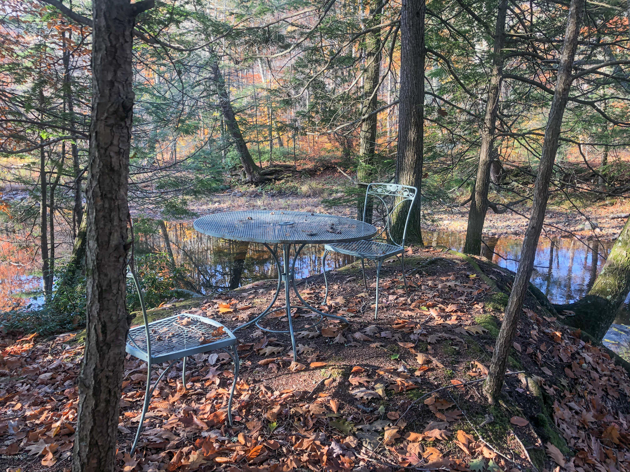 17 Bailey Road Worthington, MA 01098 - Photo 22 of 35 a view of a backyard with table and chairs under an umbrella
