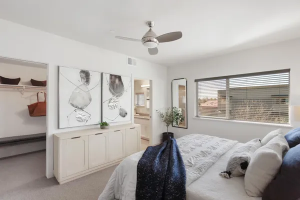 a bedroom with a large bed and a window