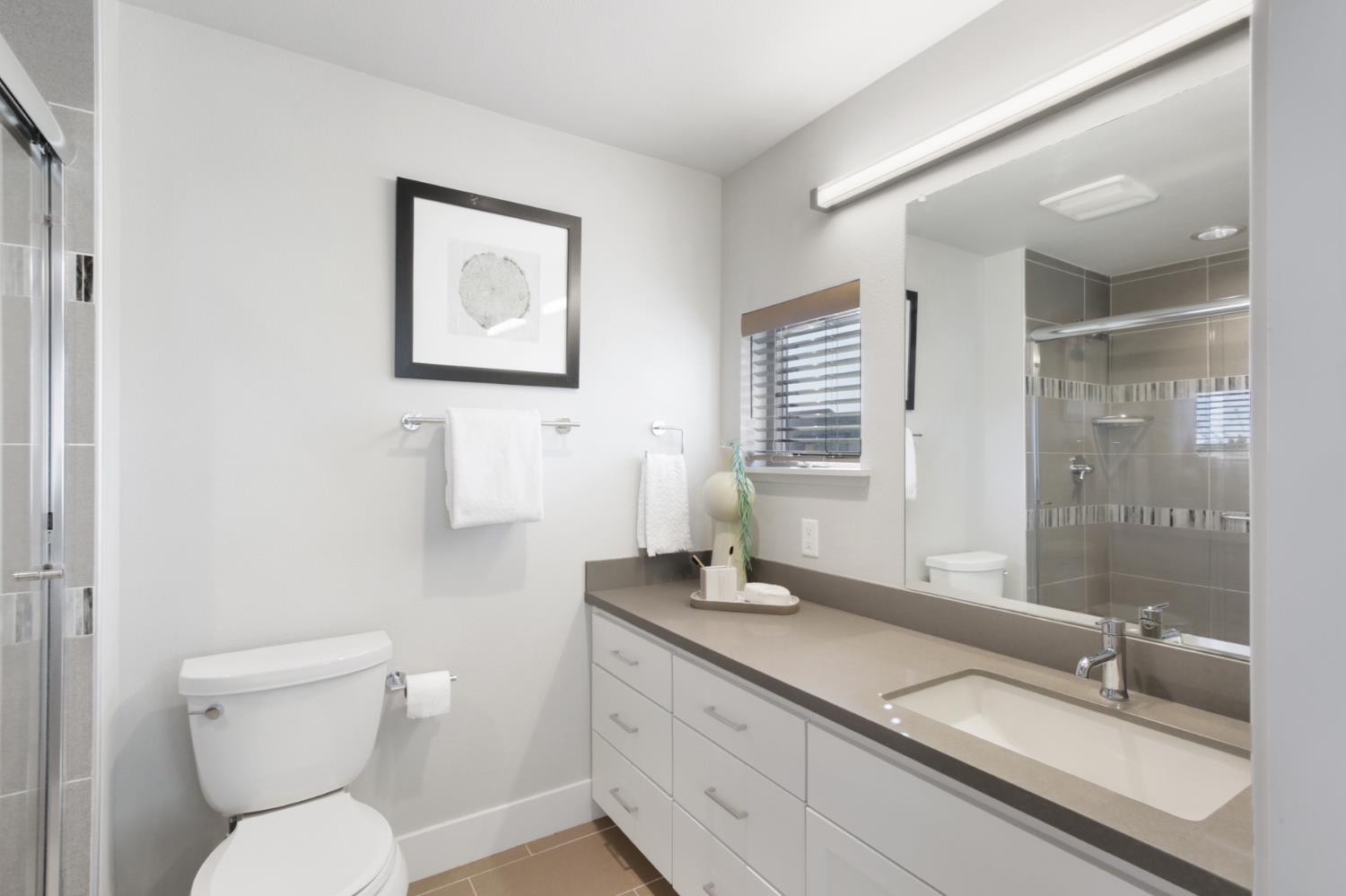 2746 5th Street Davis, CA 95618 - Photo 33 of 61 a bathroom with a toilet a sink and mirror