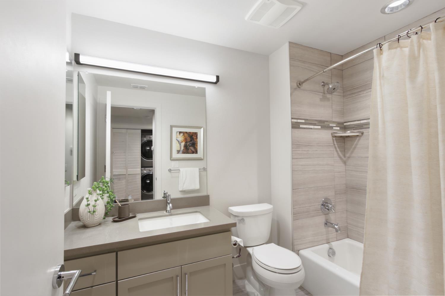 2746 5th Street Davis, CA 95618 - Photo 39 of 61 a bathroom with a sink a toilet a mirror and shower