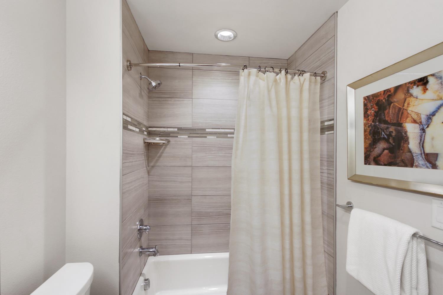 2746 5th Street Davis, CA 95618 - Photo 40 of 61 a bathroom with a shower and a toilet