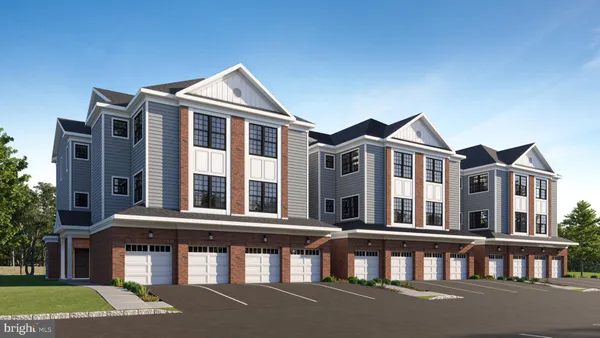 a front view of a residential apartment building with a yard
